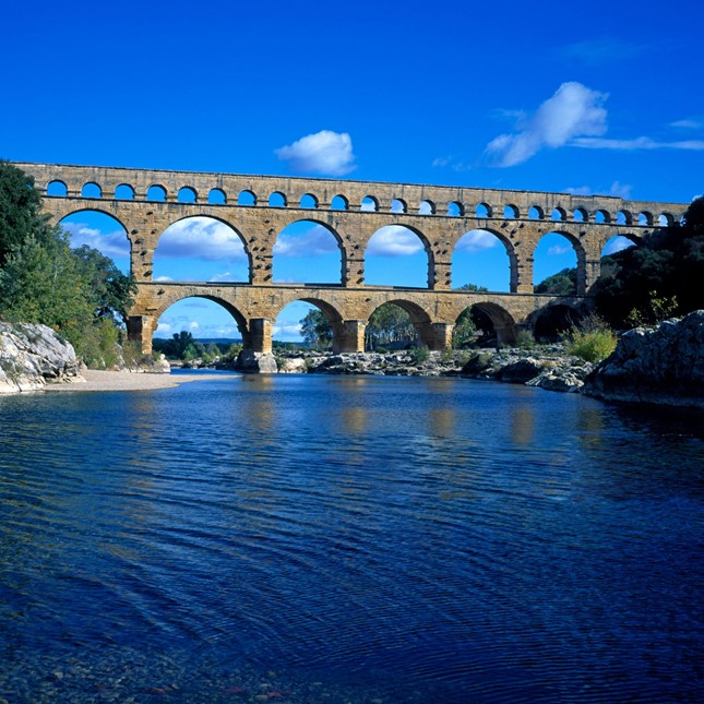 Pont du Gard is a historic Roman aqueduct which crosses the Gardon River near the town of Vers-Pont-du-Gard in southern France
